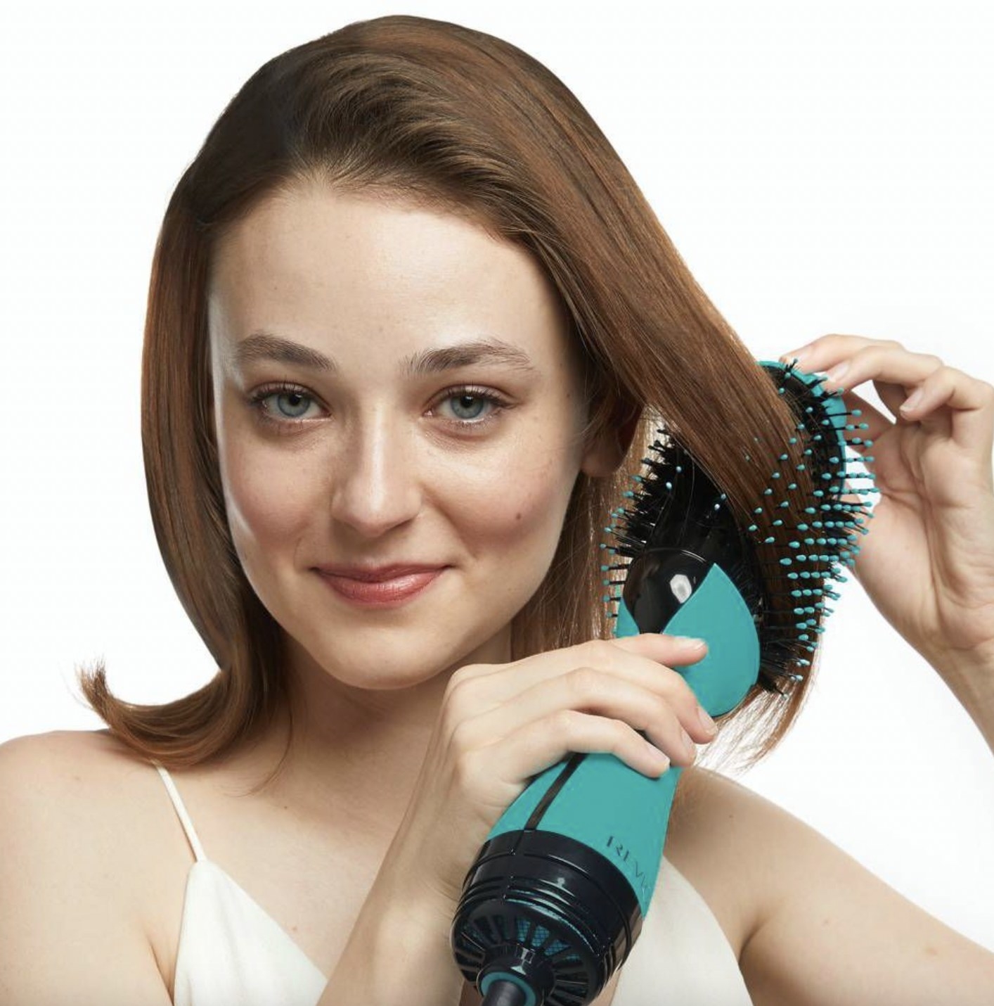 A person styling their hair with a heat-styling tool