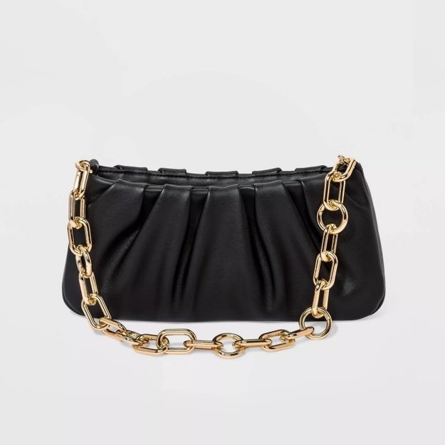 The black purse with gold handle chain