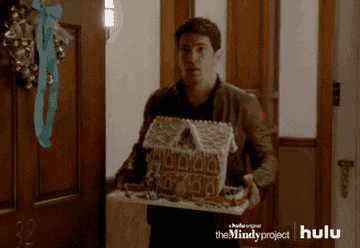 Danny holding a ginger bread house