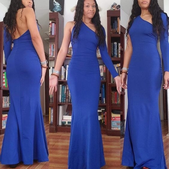 reviewer showing the front side and back of the one sleeve and dipped-back gown in blue