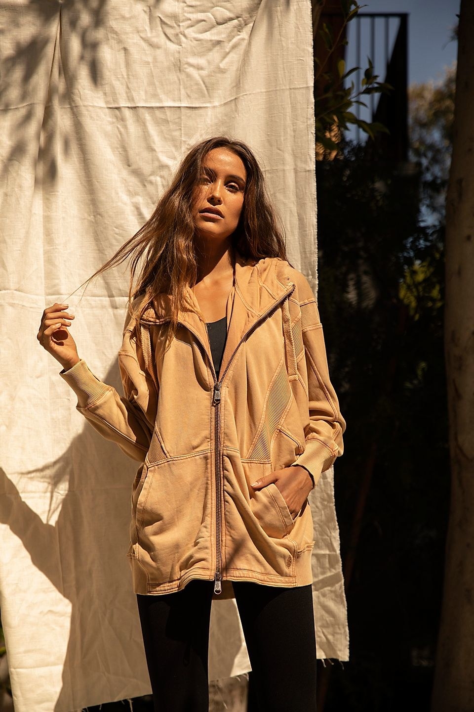 A model in the tan hoodie