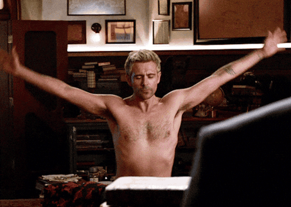 constantine from legend's of tomorrow doing yoga topless in the library