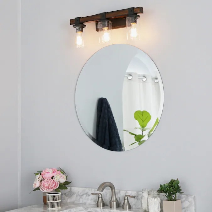 The vanity light in the color Distressed Black and Wood Tone