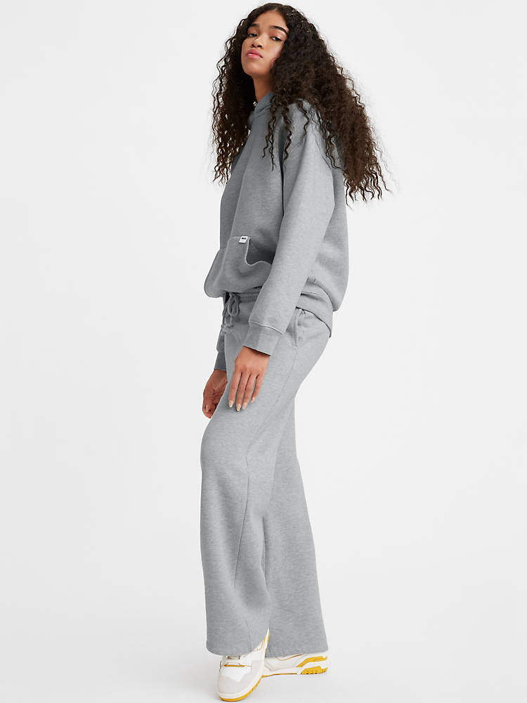 Model wearing matching grey sweatpants and sweatshirt