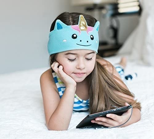 child with headphones on watching an ipad