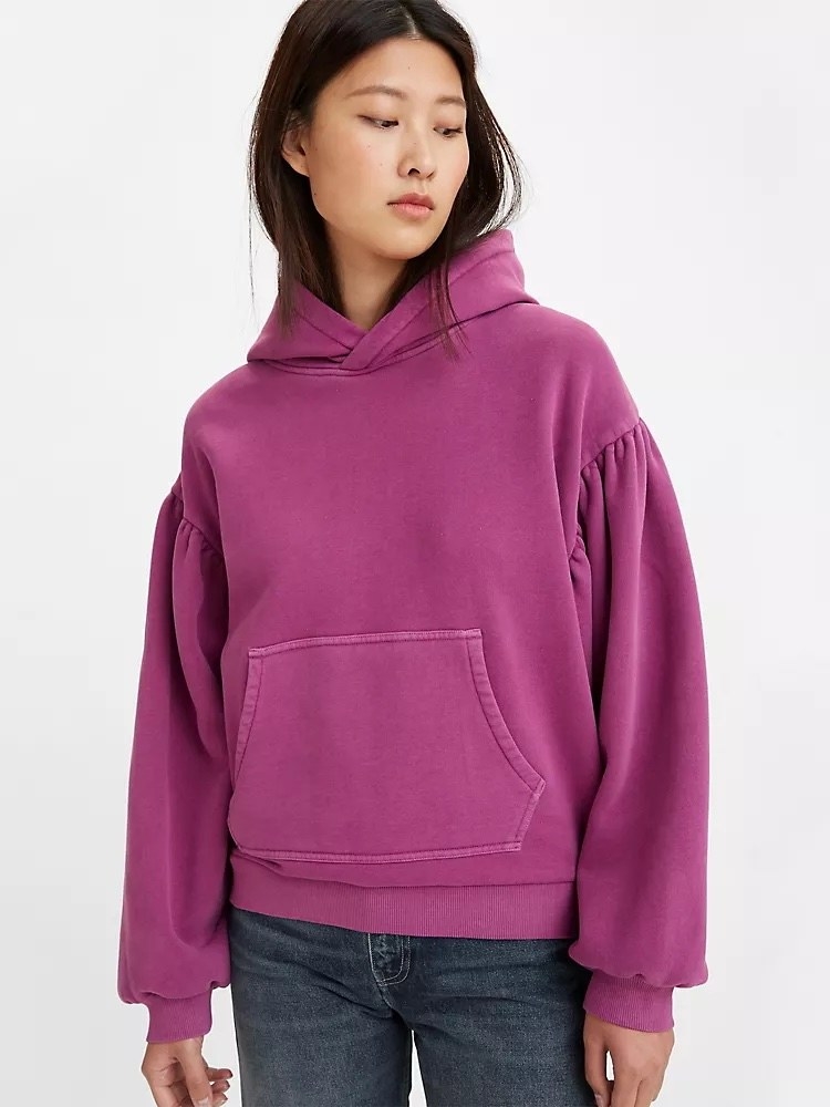 Model wearing purple hoodie with jeans