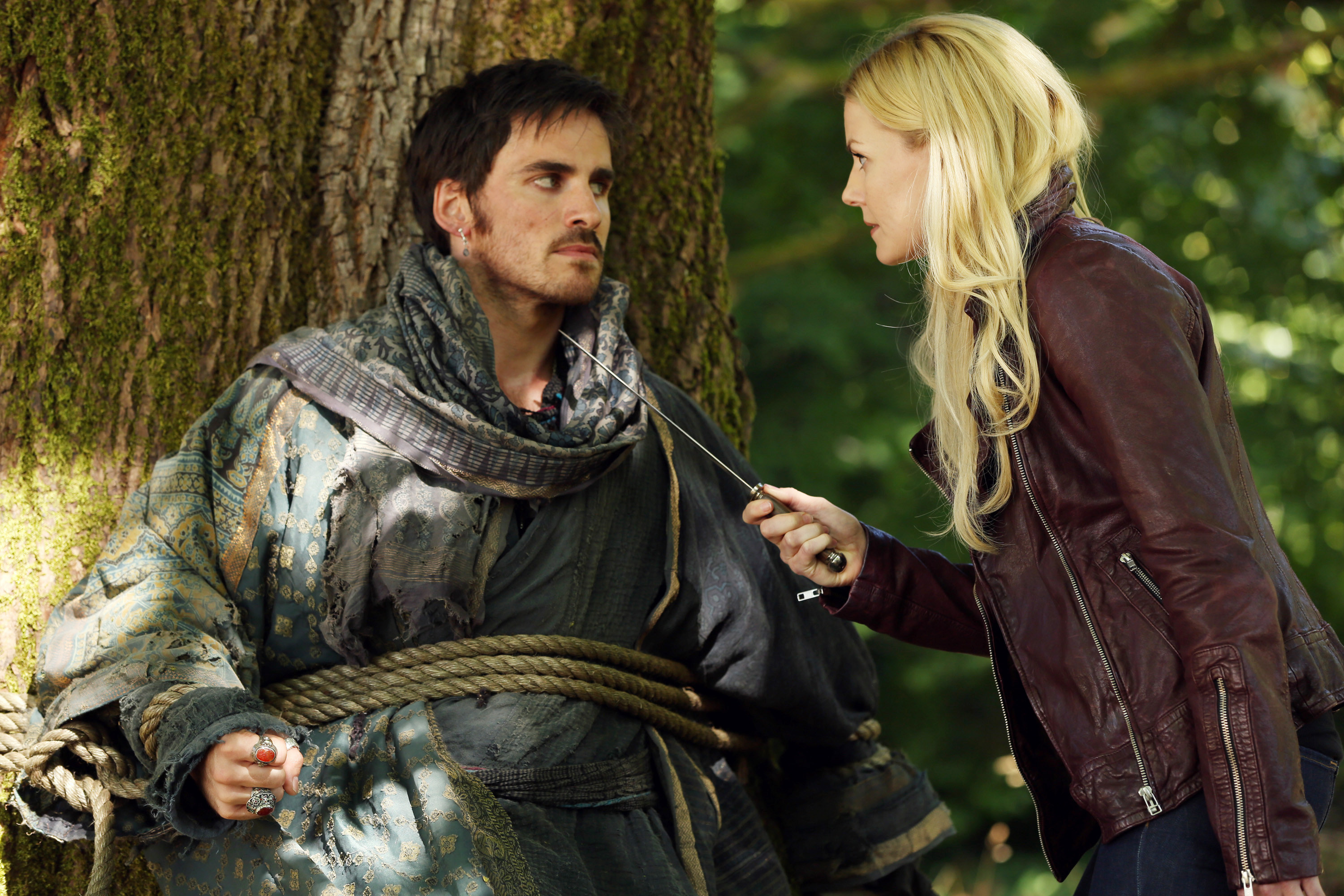 Emma Swan from &quot;Once Upon a Time&quot; holds a sword towards Captain Hook, who&#x27;s tied to a tree