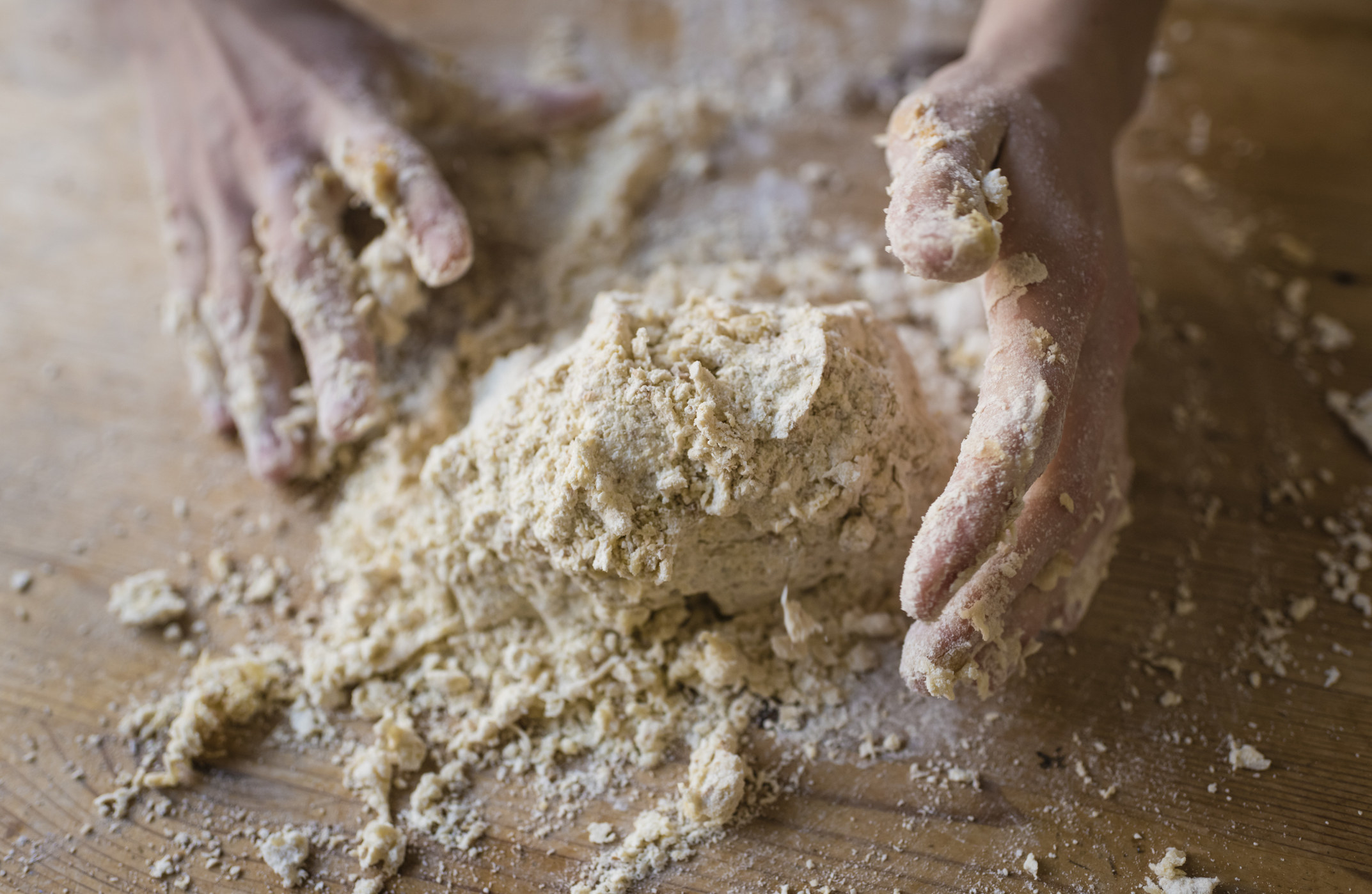 Hands kneading homemade dough