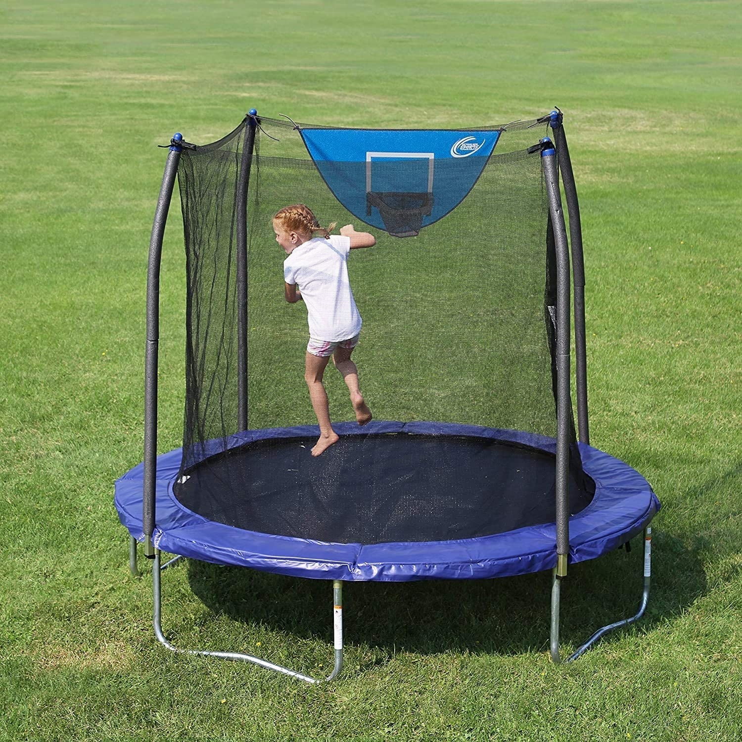 Image of a blue and black trampoline on grass with child playing inside