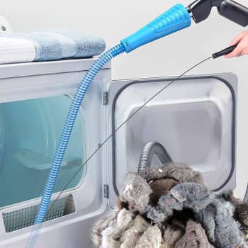 a model using the attachment to remove lint from a dryer