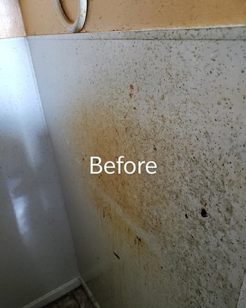 before reviewer image of a wall covered in oil and grease stains