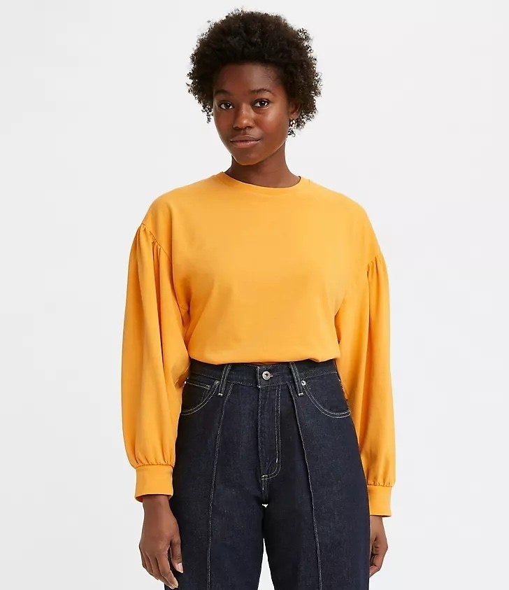 Model wearing yellow top with jeans