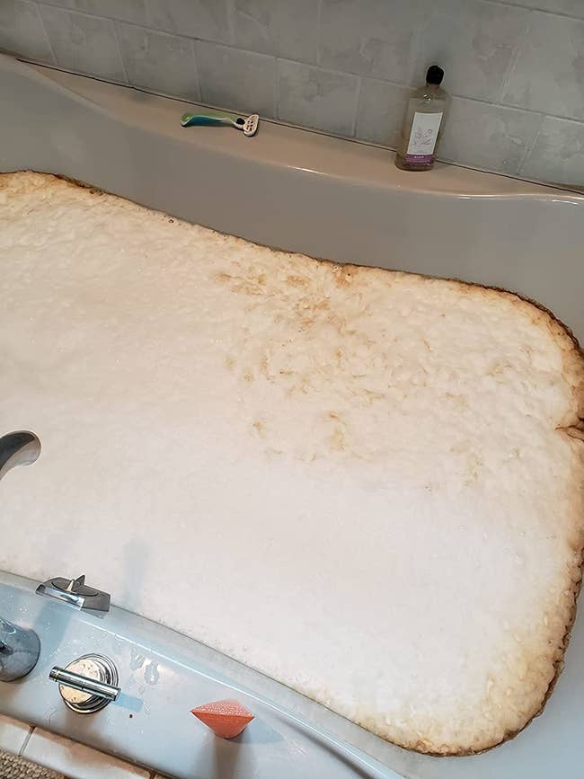 reviewer image of a dirty jetted tub being cleaned
