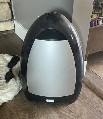 a reviewer's black and silver touchless vacuum