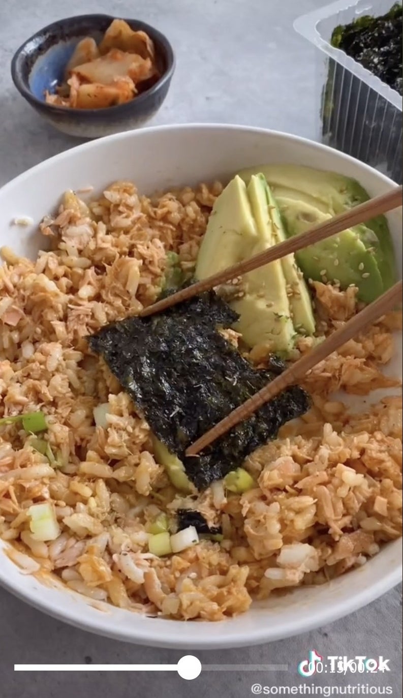 A bowl of salmon rice with kelp and scallions