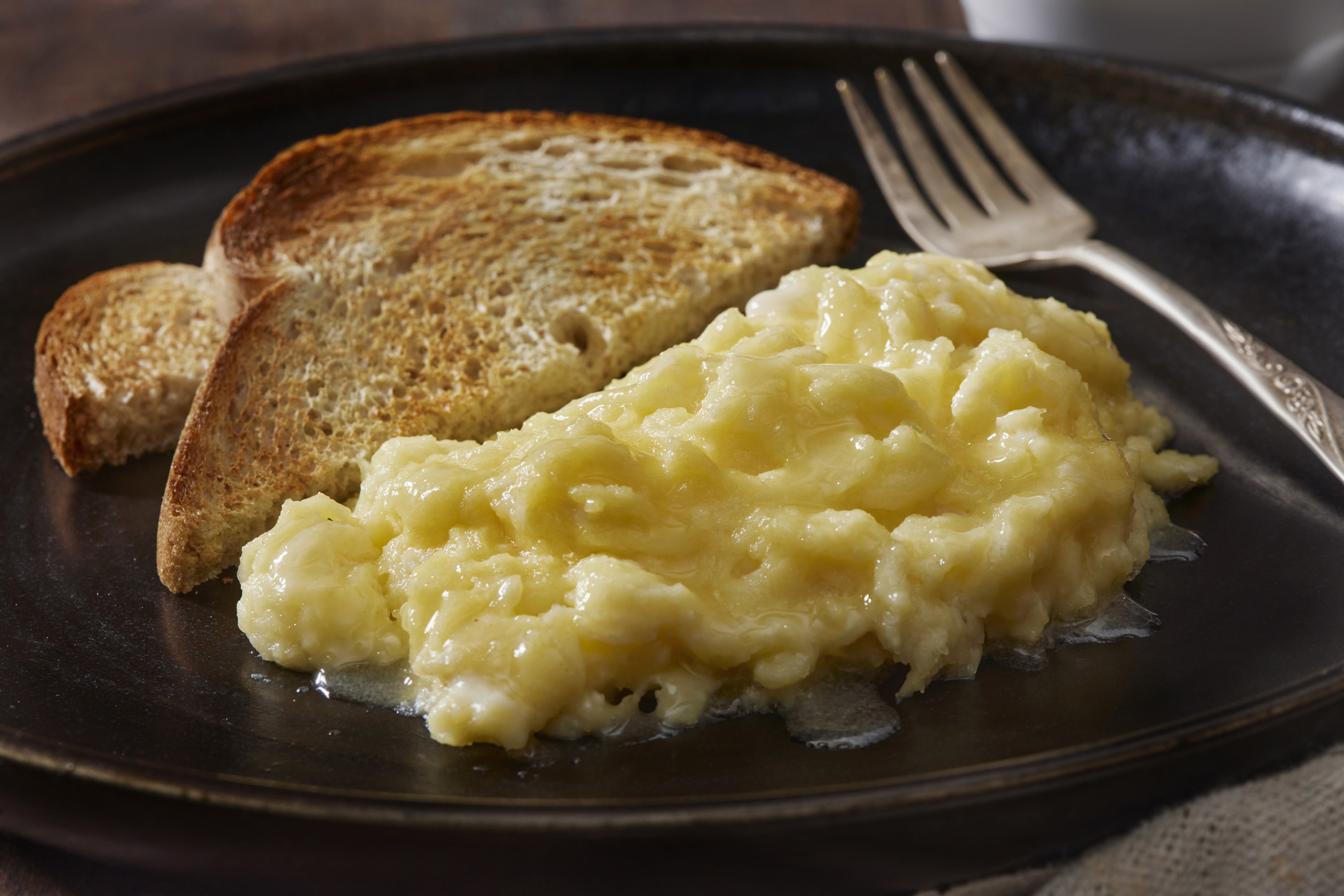 Light and fluffy scrambled eggs with toast.