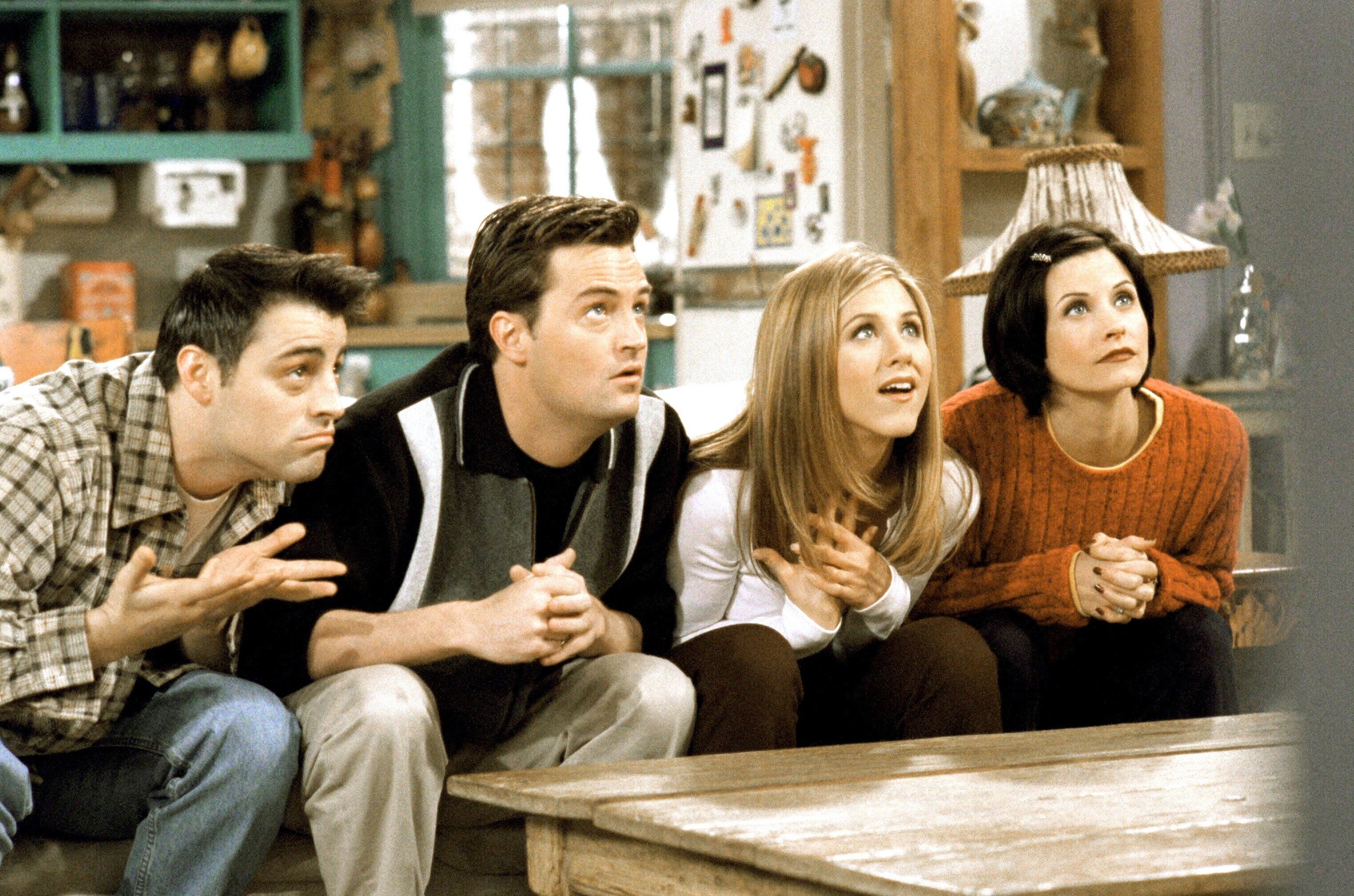 The cast of &quot;Friends&quot; all watching TV during a scene