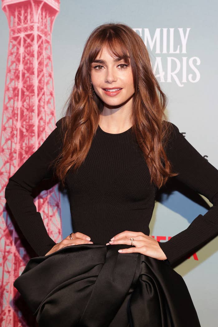 Lily at an event for the show posing on the red carpet in a long-sleeved top and a voluminous skirt