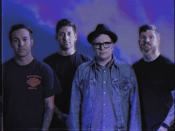 Members of Fall Out Boy doing a single, awkward wave