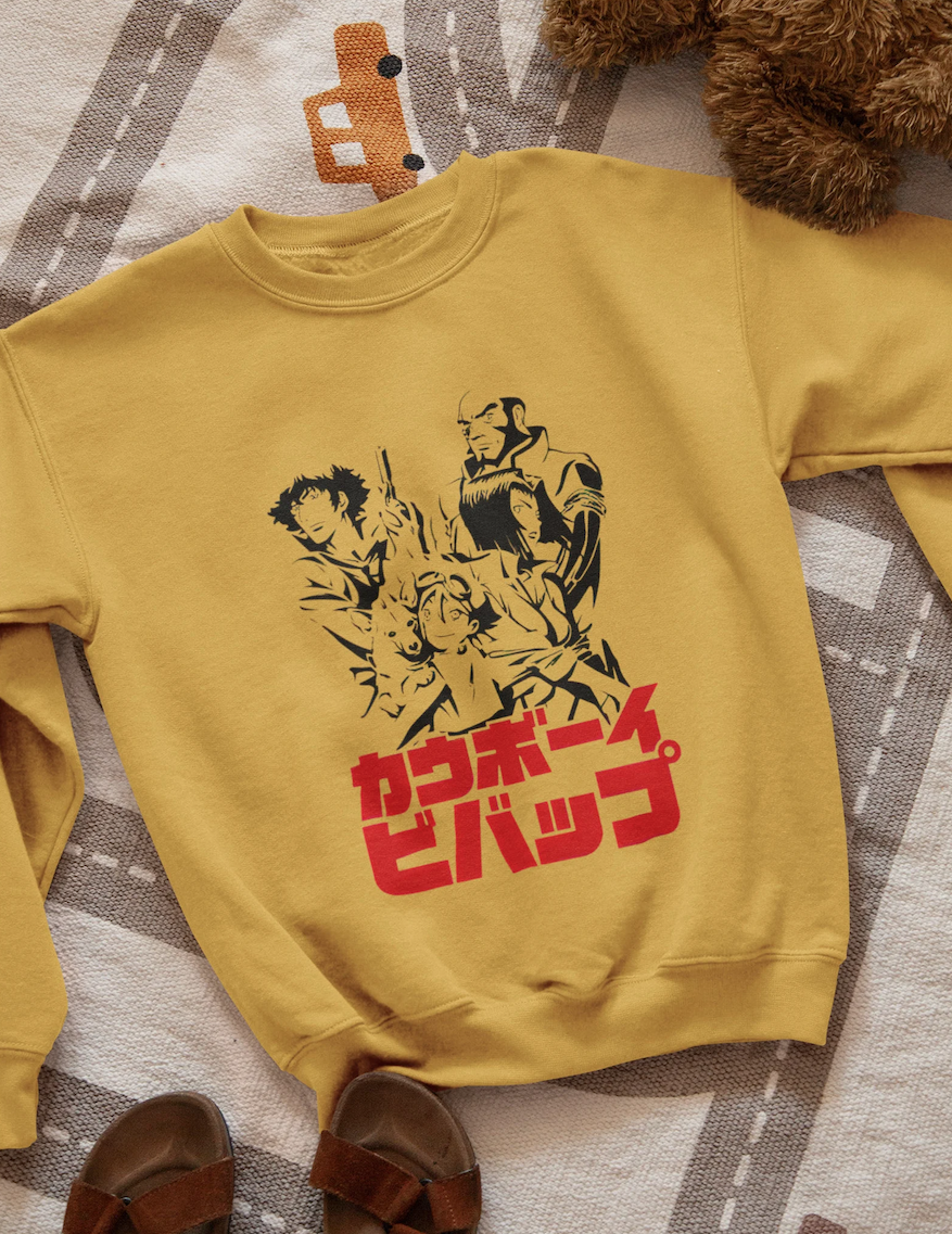A mustard yellow soft sweatshirt with a simple print of the shows characters and japanese text