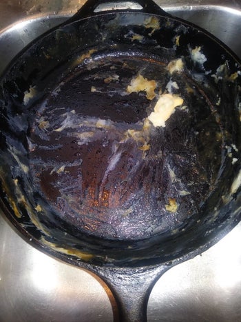 A reviewer's skillet caked with food residue