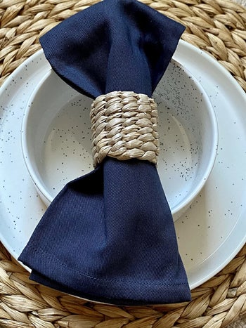 Reviewer photo of the dark blue napkin wrapped in a napkin holder at a place setting