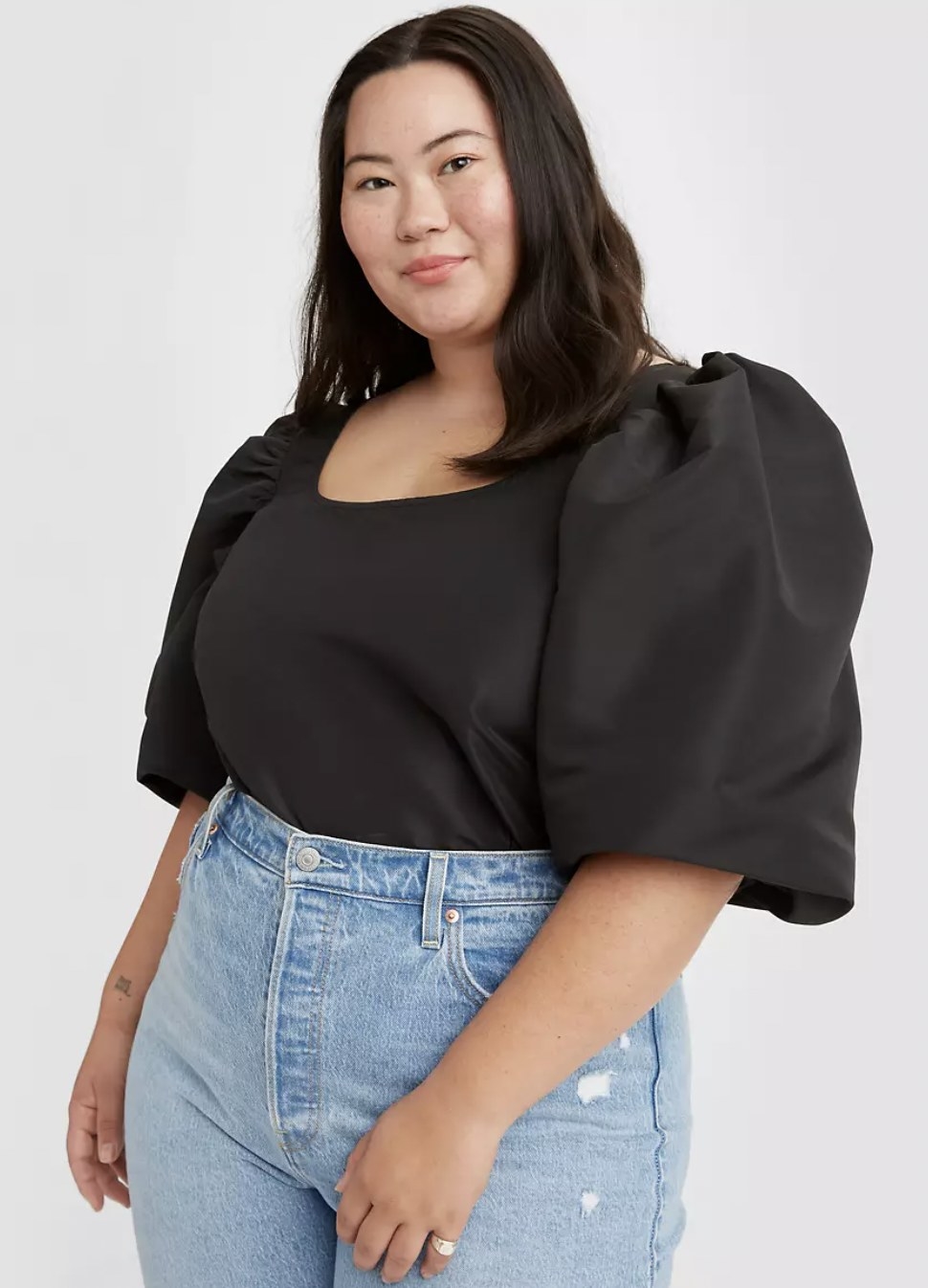 a black puff sleeve top on a model