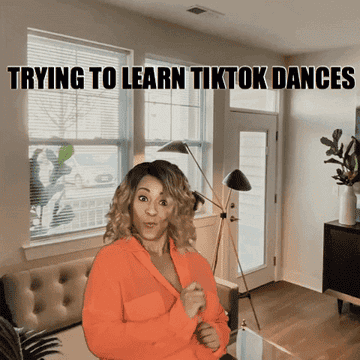 A woman looking confused doing the robot dance with the text, &quot;Trying to learn TikTok dances