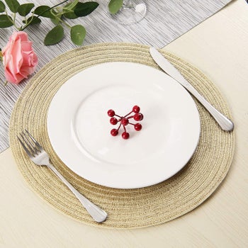 A plate, knife, and fork on the gold placemat