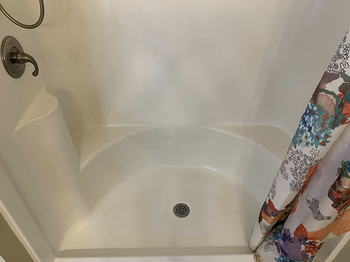the same reviewer's shower looking clean and brand new after using the stain remover