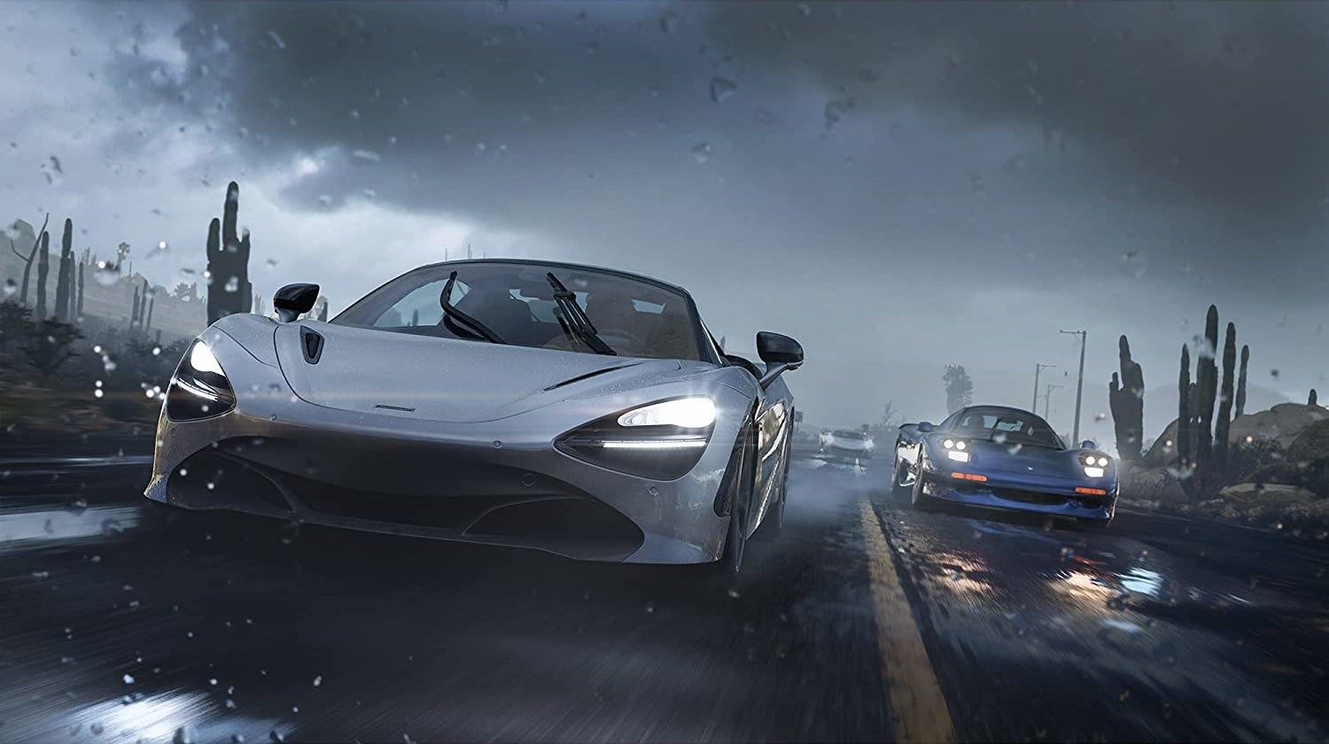 Two cars race on a rainy road