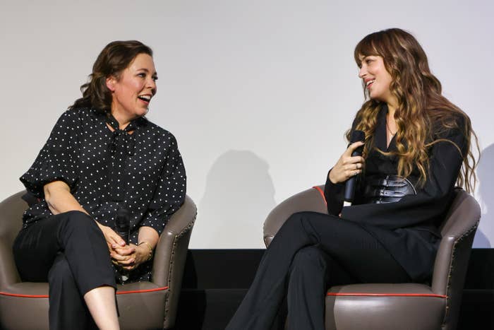 Olivia and Dakota sit on chairs onstage as they take part of a discussion