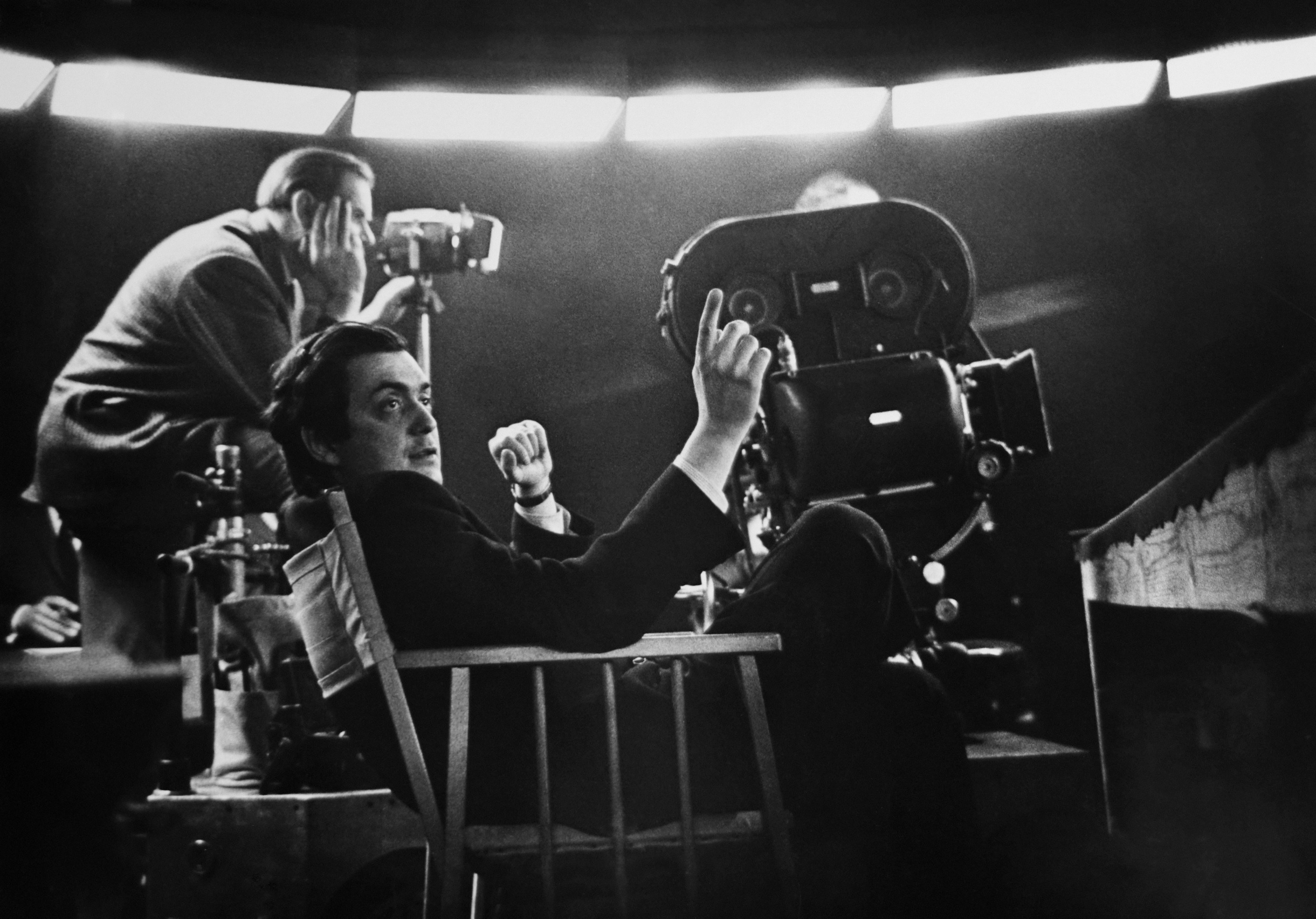Stanley sits behind a camera while making a film