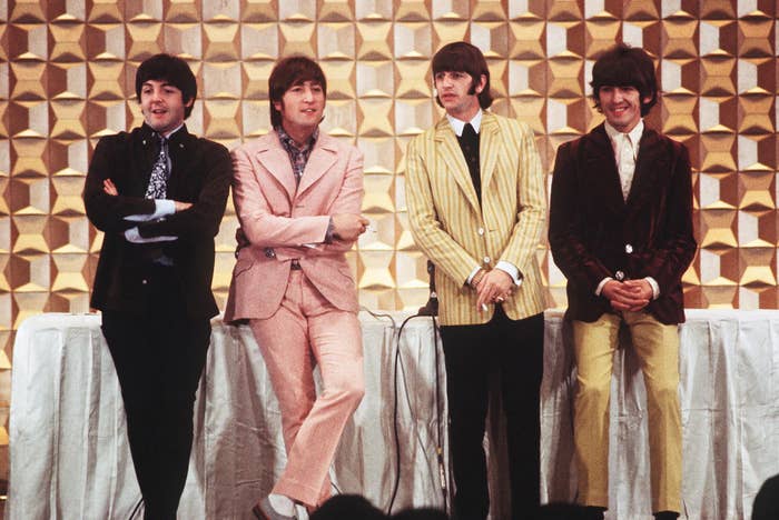 The Beatles stand during a press conference