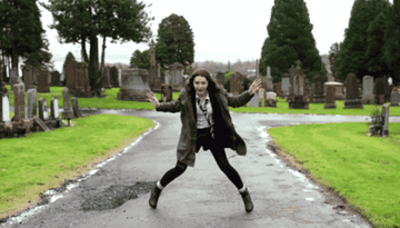 Girl dances in a graveyard
