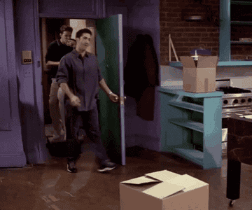 Joey and Chandler from &quot;Friends&quot; riding a dog statue into Monica&#x27;s apartment.