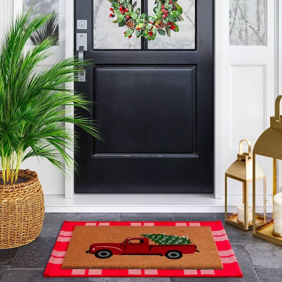 Door mat shown in front of a black front door
