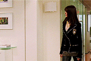 Andy from the devil wears prada strutting into the office in the chanel boots and blazer outfit