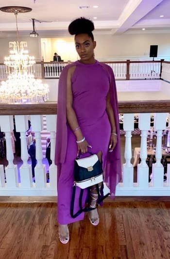 reviewer in the sleeveless maxi dress with a floor length long cape in bright purple