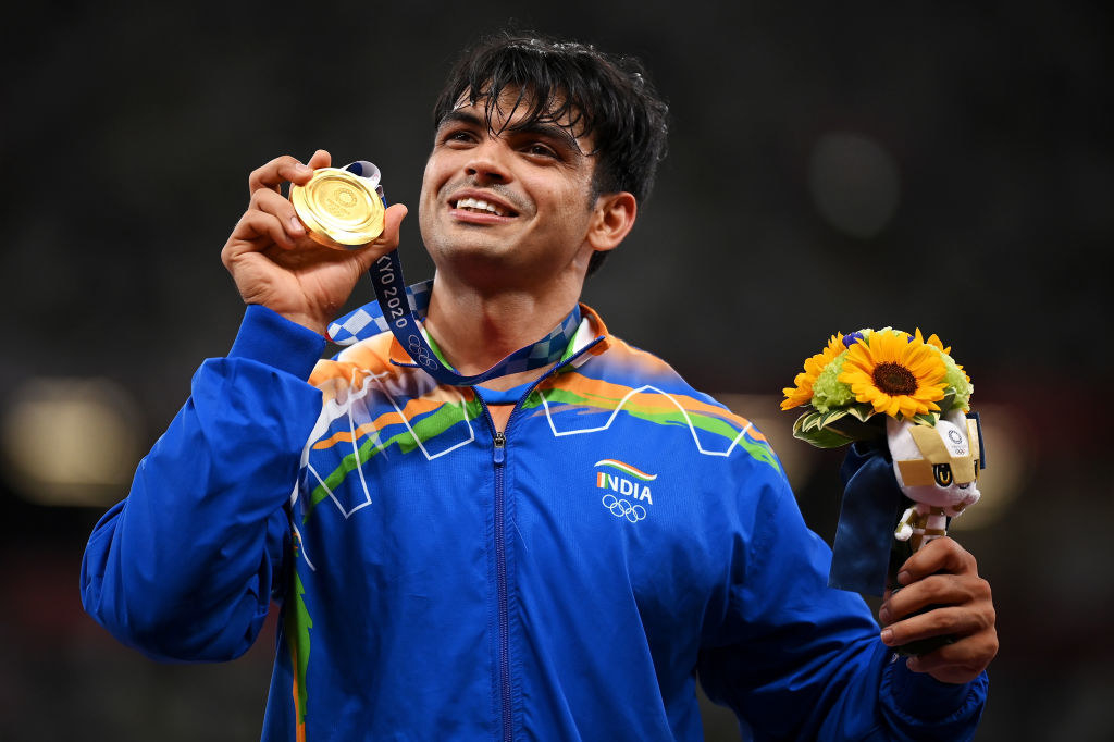 Indian athlete and Gold medalist Neeraj Chopra displaying his gold medal for Javelin throw at the Tokyo Olympics.