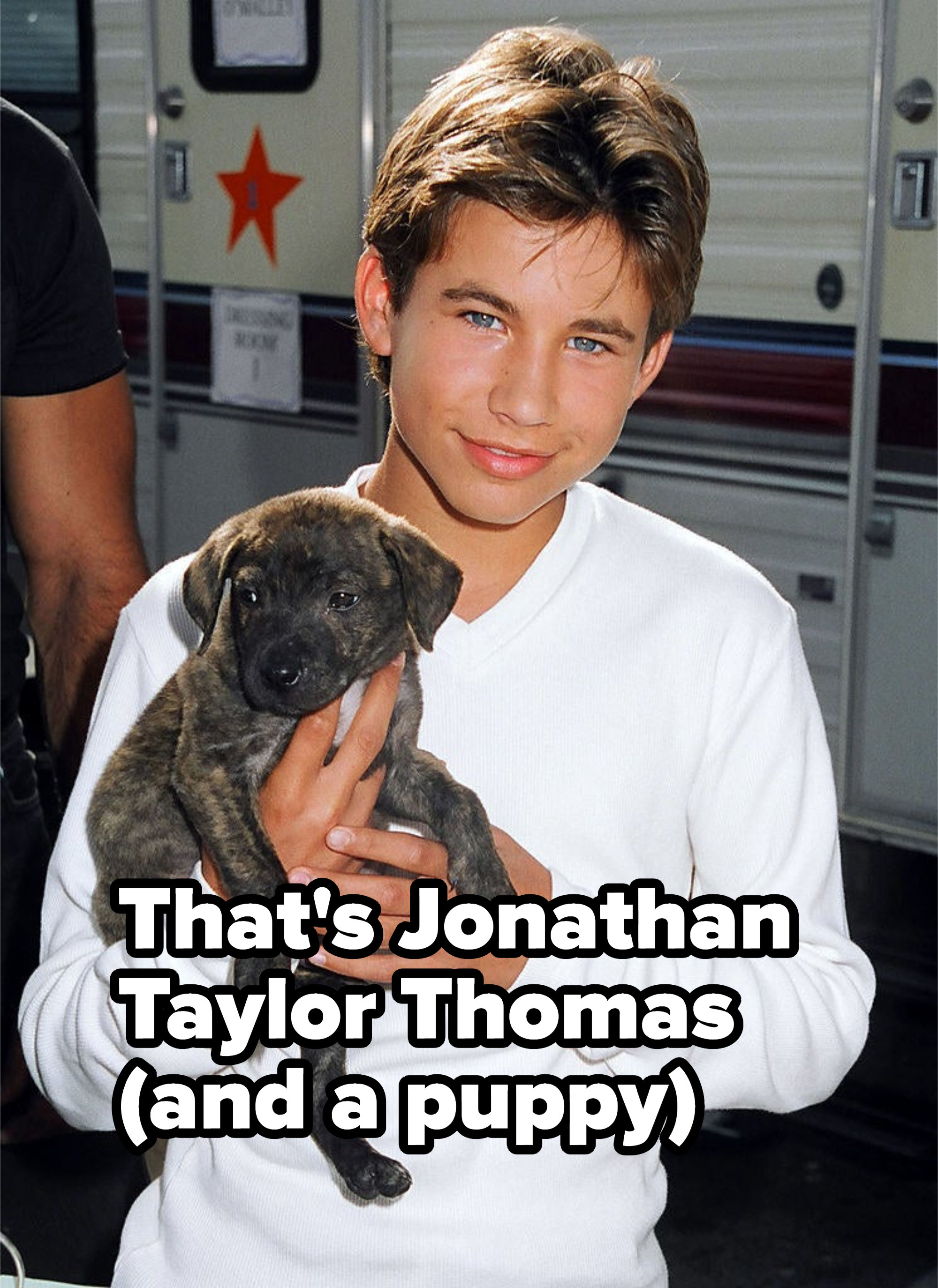 JTT is holding a puppy