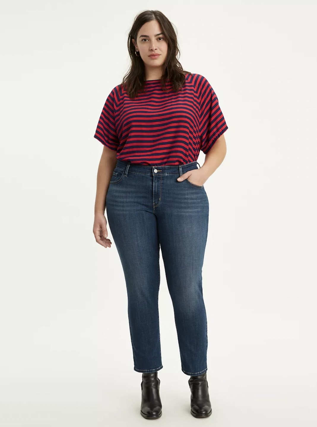 Model wearing the dark blue wash jeans with ankle boots and striped tee