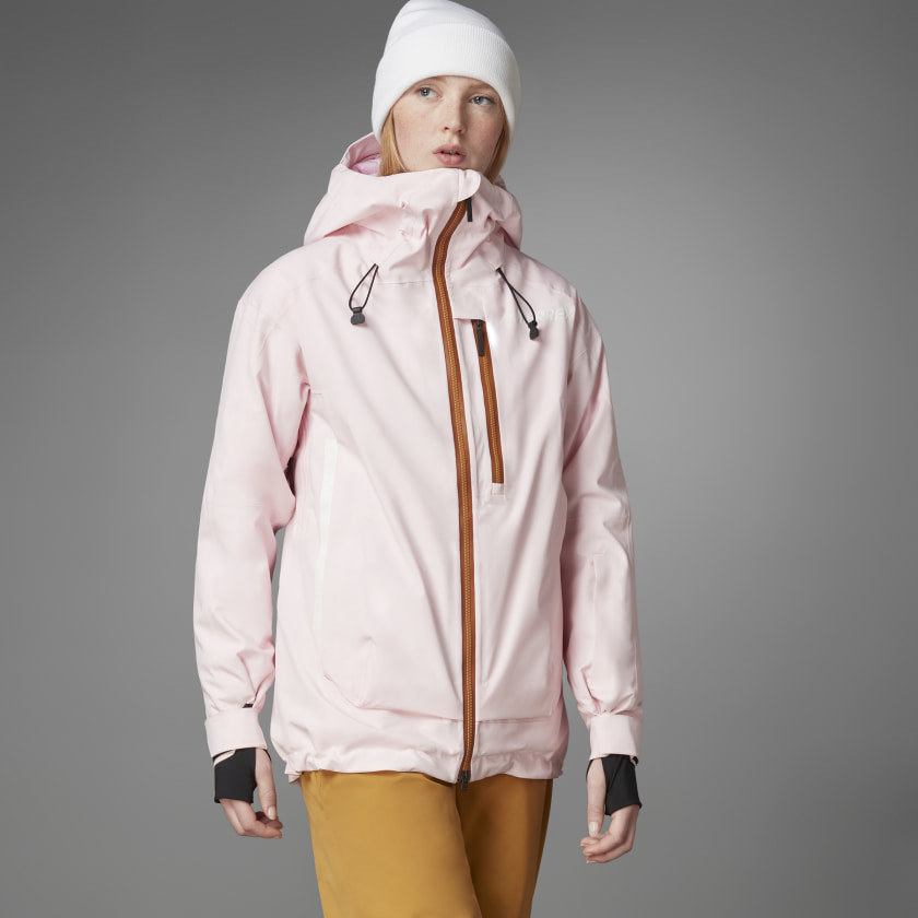 An adult is wearing the light pink zip-up jacket with brown color zips and a bungee hood