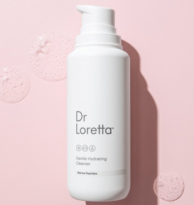 a white bottle that says &quot;Dr. Loretta gentle hydrating cleanser&quot; against a pink background