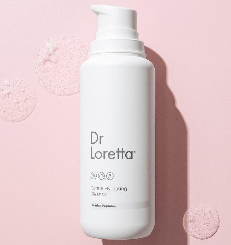 a white bottle that says "Dr. Loretta gentle hydrating cleanser" against a pink background