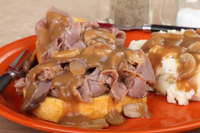 An open faced roast beef sandwich with gravy.