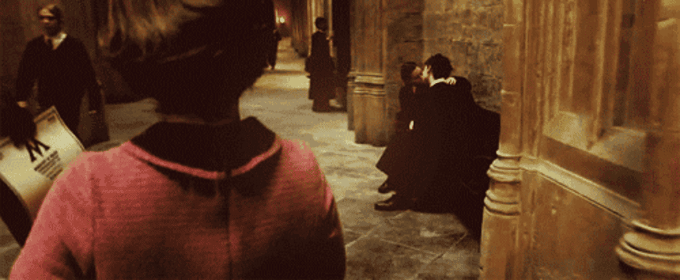 Umbridge walks through the hall and casts a spell separating two students