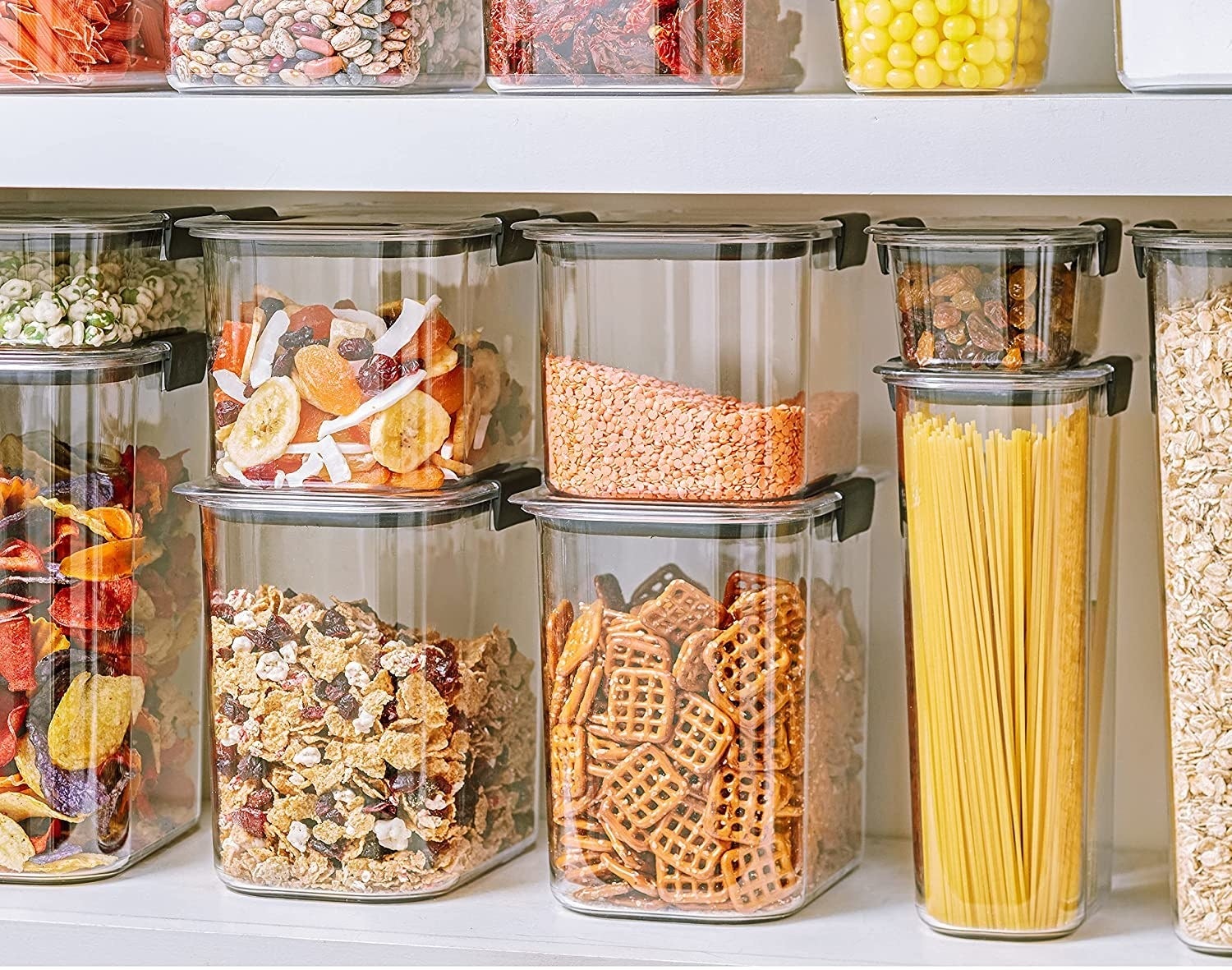 clear food storage containers filled with cereal, pasta, flour, and more