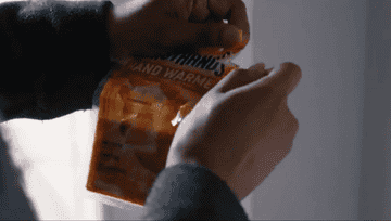 GIF of someone opening the hand warmers and rubbing them between their hands