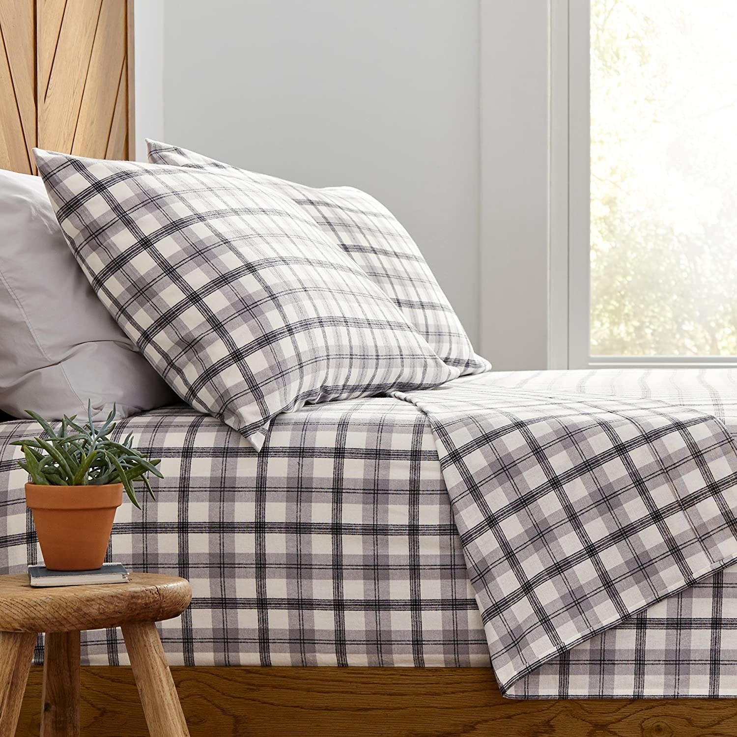 A bed with flannel bed sheets on it